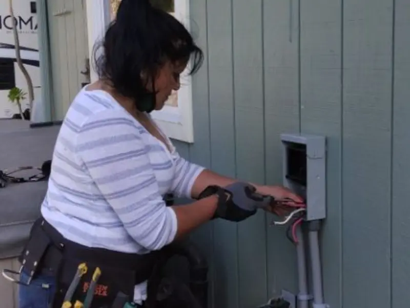 Licensed electrician wiring an exterior subpanel in Beaverton